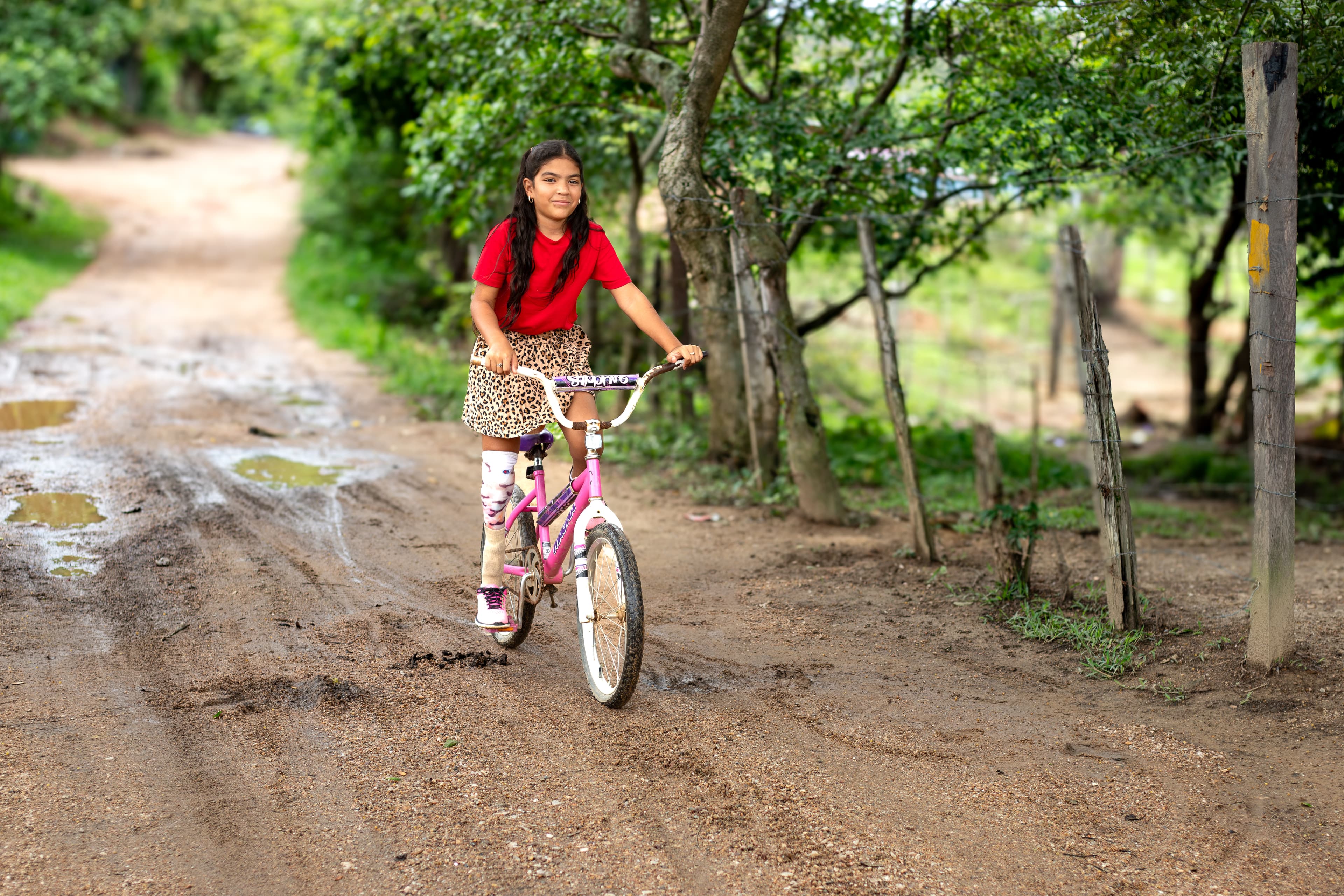 Connie rides her bike down the road