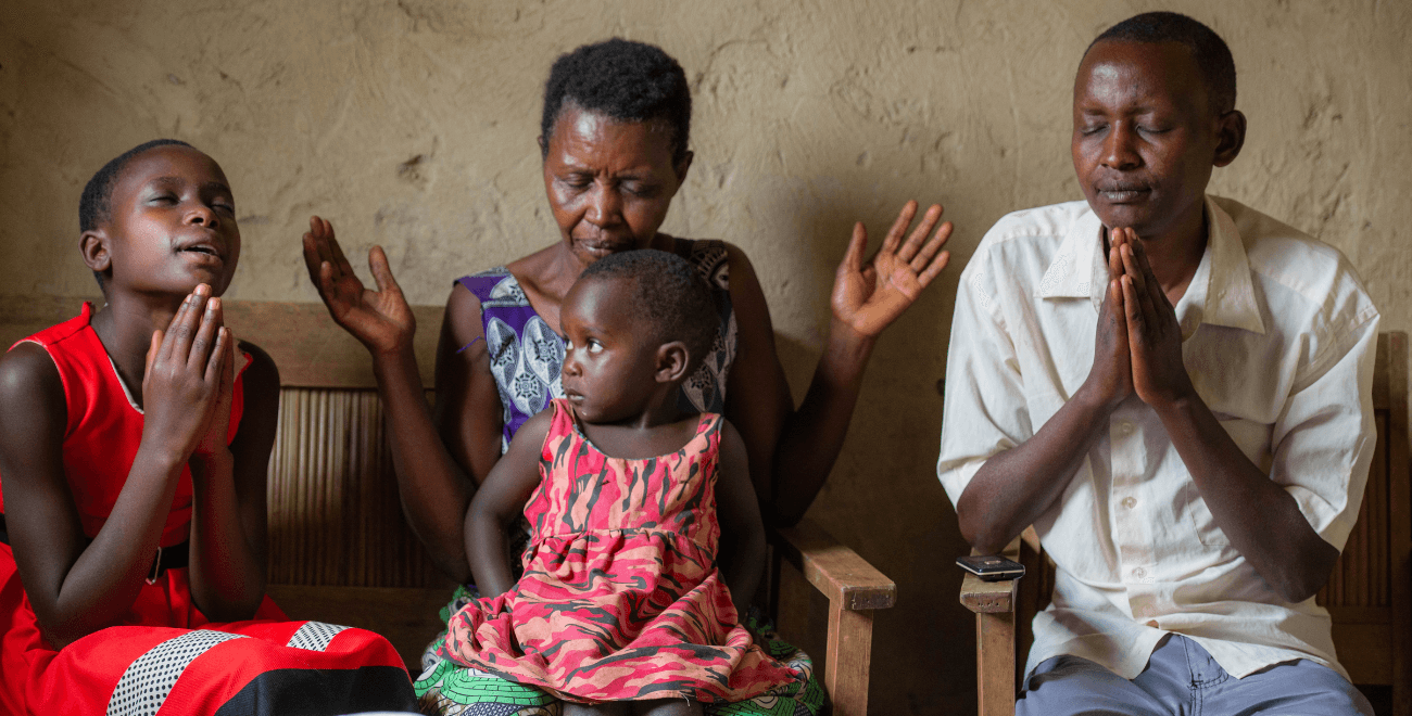 A family pray in Uganda
