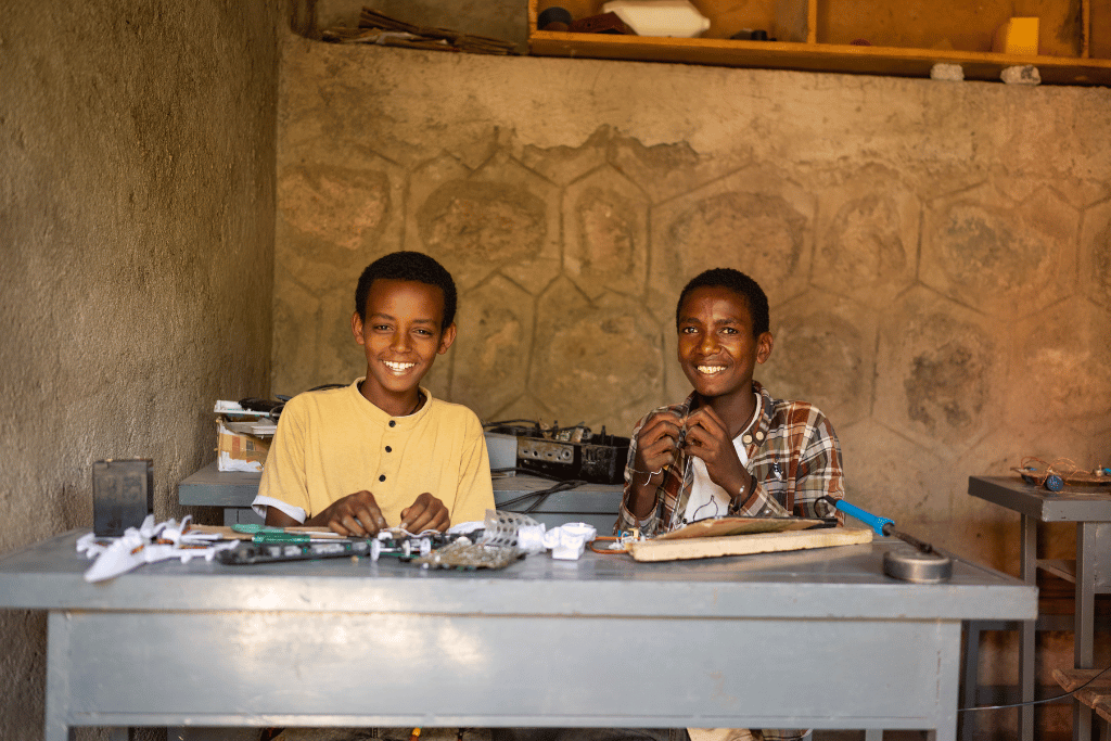 Two boys learning electronics skills in Ethiopia