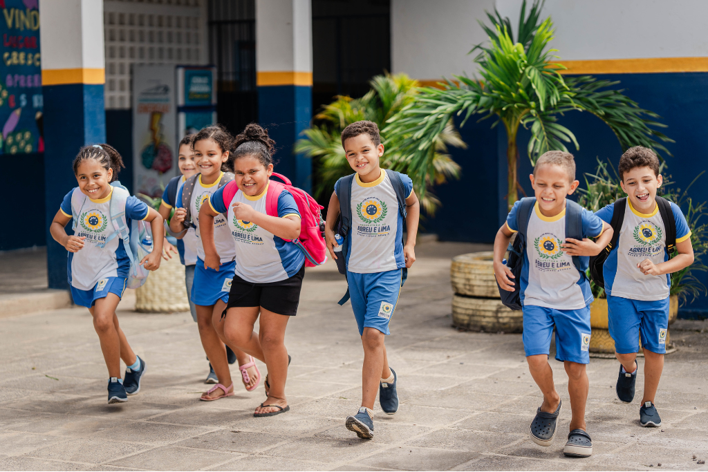 Thomas and his friends run in front of their school in Brazil